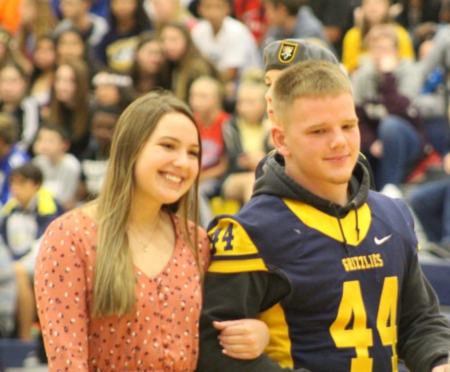 Josh Carter (12) and Katie Carter (12) walk at the homecoming pep assembly
