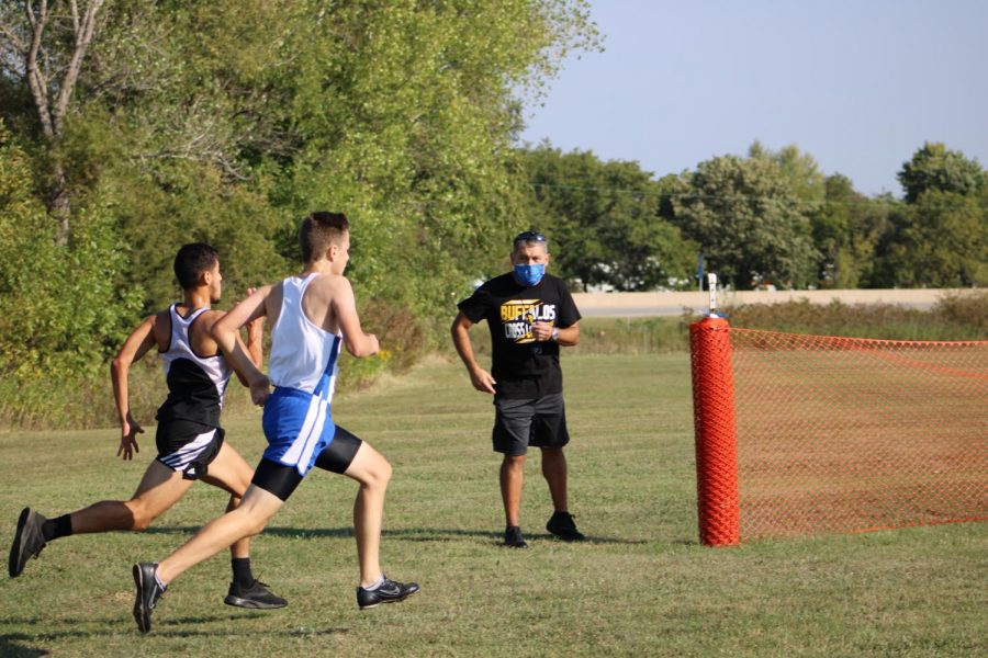 Racing against a Southeast runner to the finish line, freshman Gabe Brown finishes strong. 