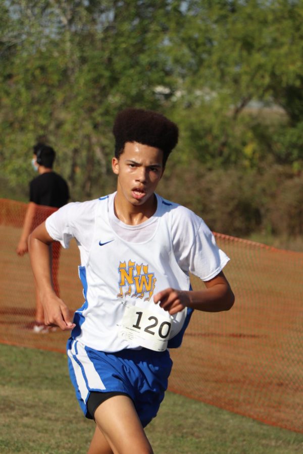 Charles Chege competes in the varsity race as a freshman winding up with a sixth place finish. 