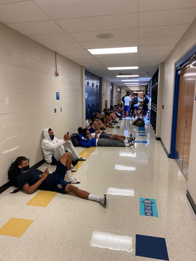 Students kill time in the hallway waiting for practice to begin on Sept. 18.