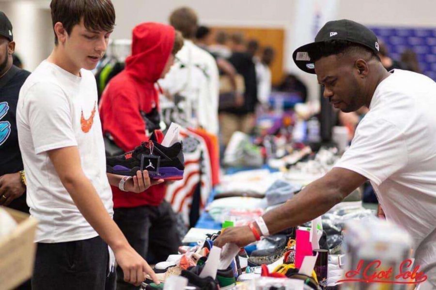 Cj  Rincones looks at shoes to buy while he is at shoe show in Wichita.