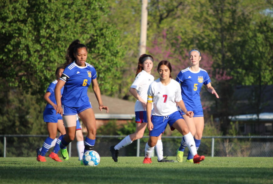 Zoe Baker (11) dribbling the ball down field 