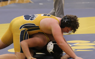 Chase Allen (11) is on top of his opponent. 