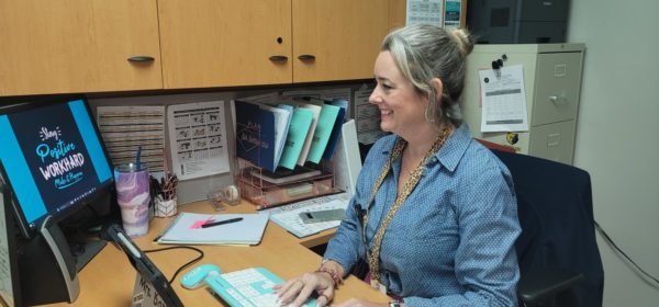 Mrs. Bartsch working at her desk in the office.