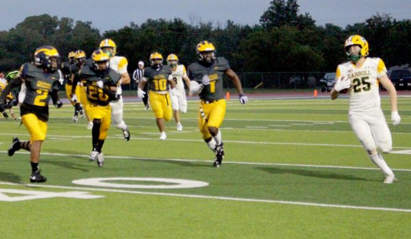 At the game against Bishop Carroll on Sept. 5 Johnmichael Fountain drives the opponent out of bounds. 